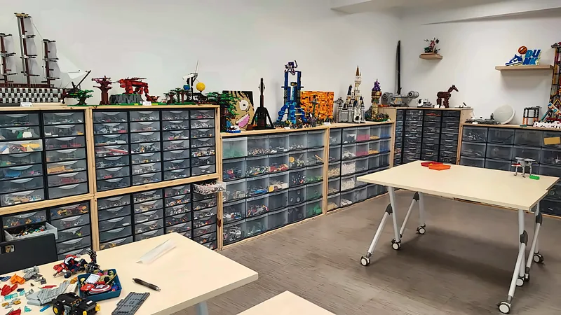 Salle du club de construction à Salon-de-Provence : tiroirs de pièces LEGO® triées et créations exposées